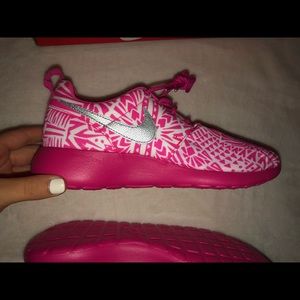 Pink and white nike roshes
